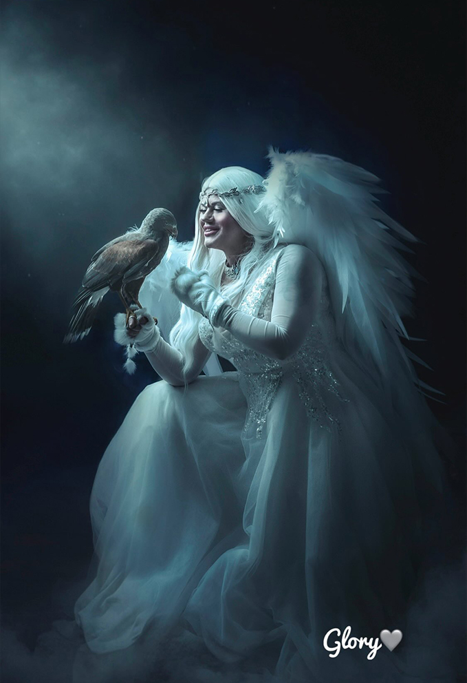 young angel woman posing with hawk like heaven